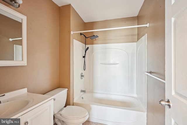 bathroom with toilet, vanity, and shower / washtub combination