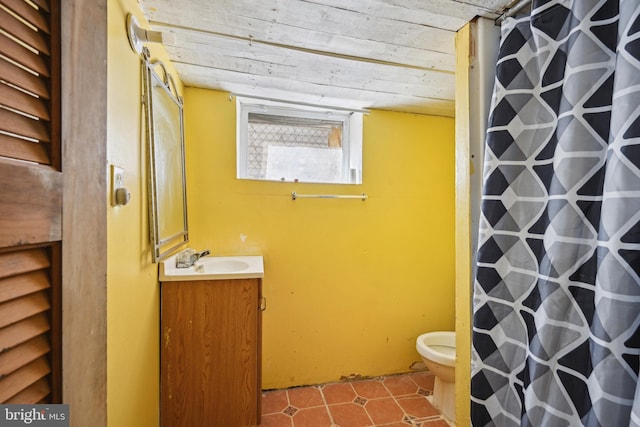 full bathroom featuring toilet, vanity, curtained shower, and tile patterned floors