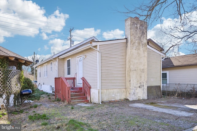 rear view of house featuring fence