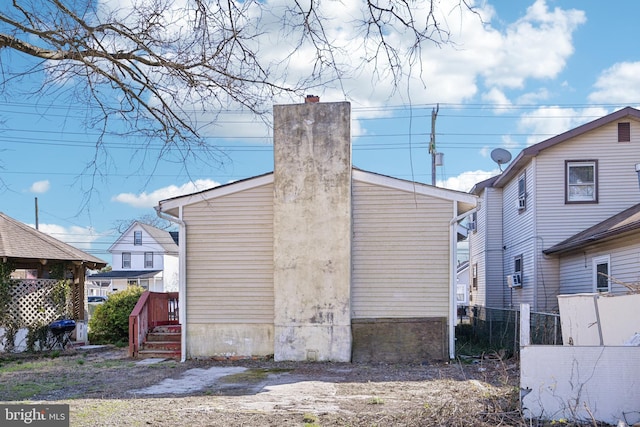 view of outbuilding with fence
