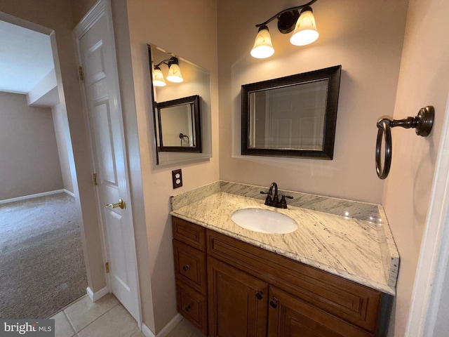 bathroom with baseboards, tile patterned floors, and vanity