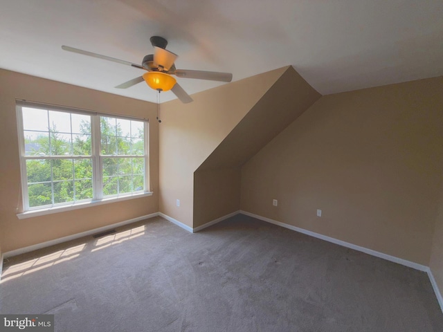 additional living space featuring carpet floors, baseboards, and ceiling fan