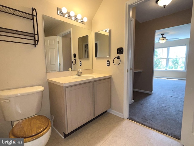 bathroom featuring vanity, ceiling fan, baseboards, and toilet