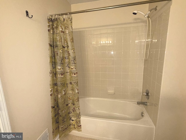 bathroom featuring shower / bath combo with shower curtain