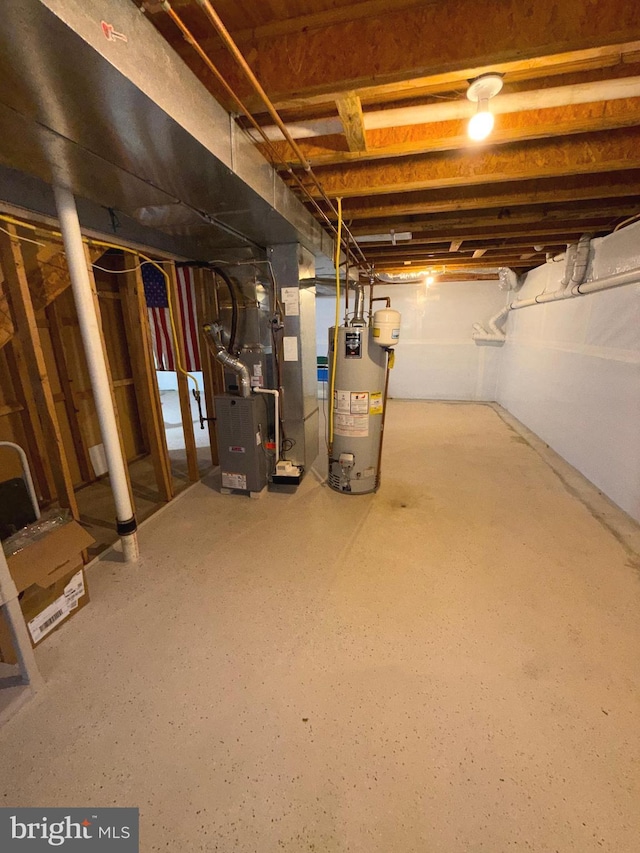 unfinished below grade area featuring heating unit and gas water heater