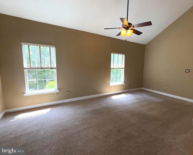 carpeted spare room with baseboards, ceiling fan, vaulted ceiling, and a wealth of natural light