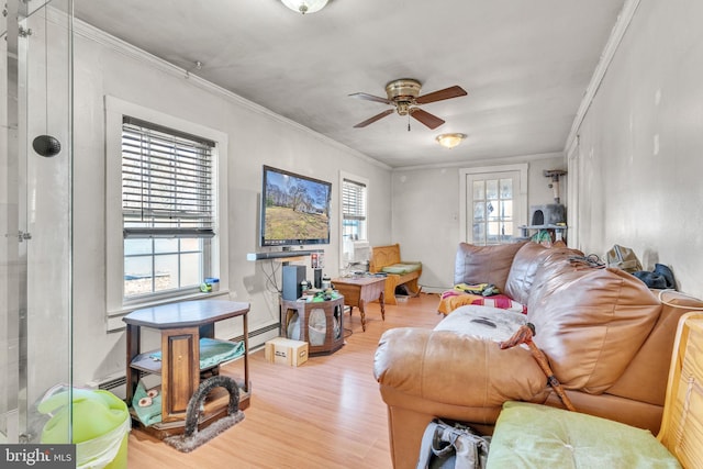 living area with light wood-type flooring, crown molding, ceiling fan, and baseboard heating