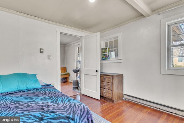 bedroom featuring hardwood / wood-style floors, ornamental molding, a baseboard heating unit, and beamed ceiling
