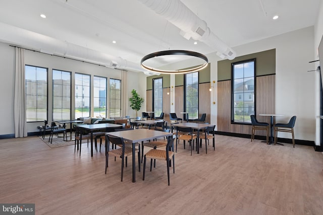 dining room featuring light wood-style flooring, baseboards, and recessed lighting
