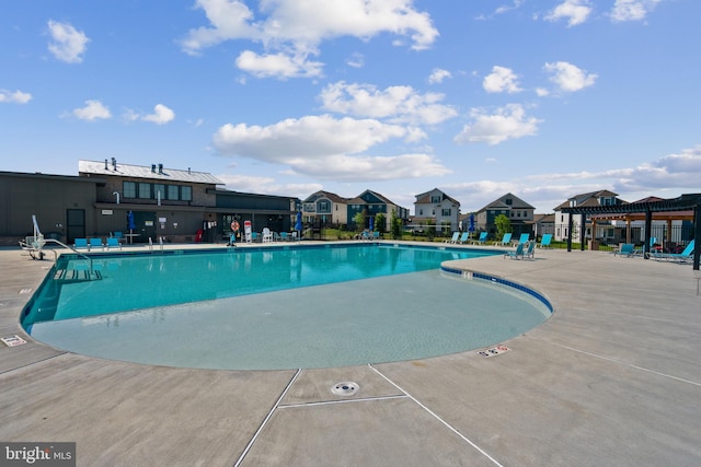 community pool with a patio and a residential view