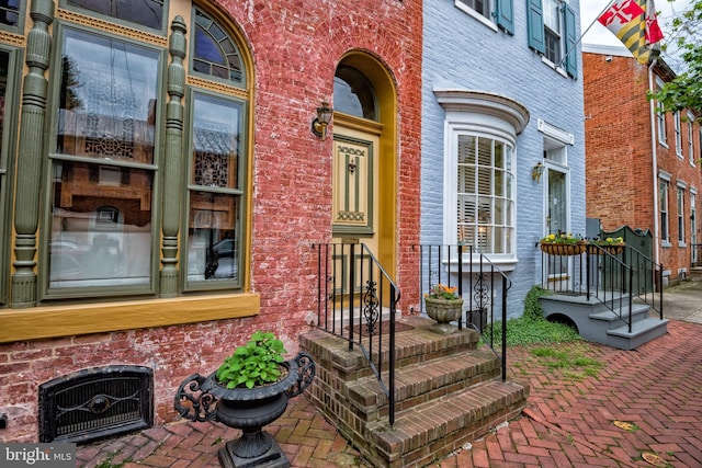 doorway to property with brick siding