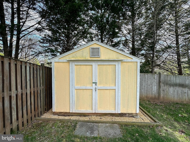 view of shed with a fenced backyard