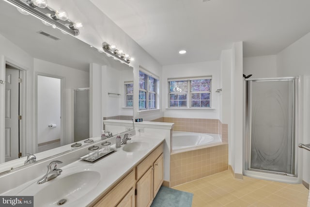 full bath with a shower stall, tile patterned flooring, a sink, and visible vents