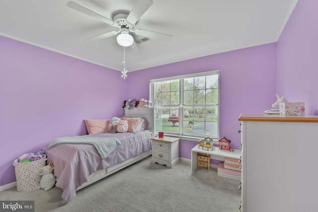 carpeted bedroom with a ceiling fan, baseboards, and ornamental molding