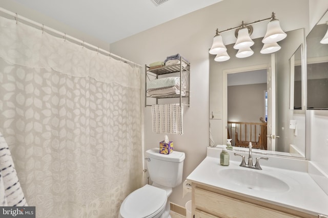 bathroom featuring toilet, vanity, a shower with shower curtain, and visible vents