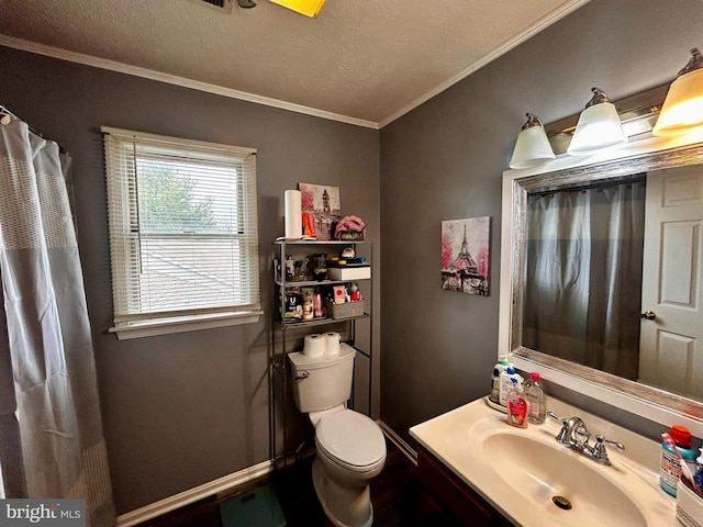 bathroom with toilet, ornamental molding, vanity, and a textured ceiling