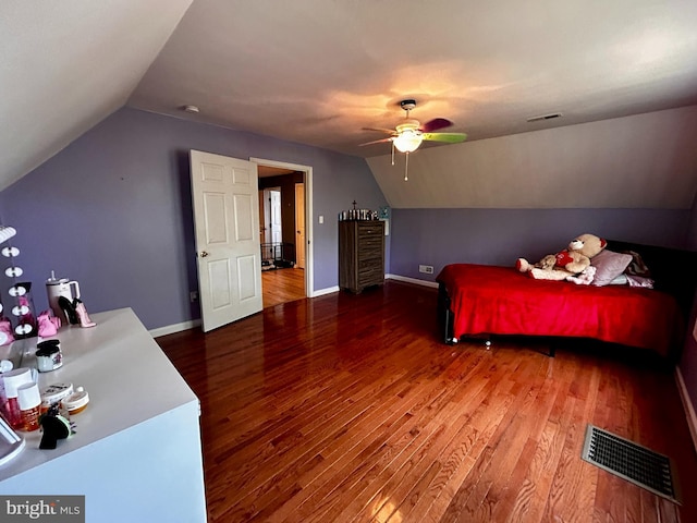 bedroom with wood finished floors, vaulted ceiling, and visible vents