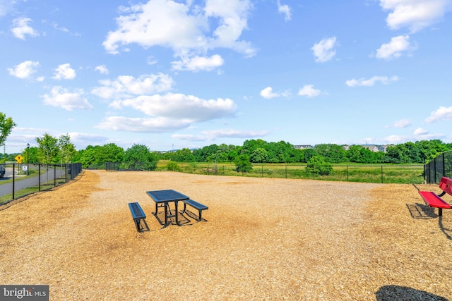 surrounding community featuring fence and a view of rural / pastoral area