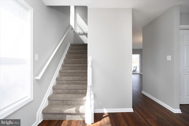 stairs featuring baseboards and wood finished floors