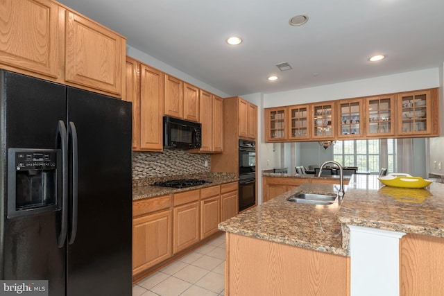 2804 Persimmon Pl Unit D3, Cambridge, MD 21613 - kitchen featuring visible vents, glass insert cabinets, a sink, black appliances, and light tile patterned flooring