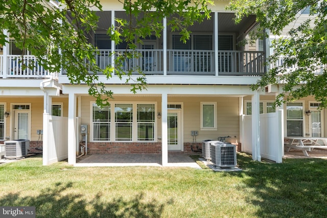 2804 Persimmon Pl Unit D3, Cambridge, MD 21613 - back of house with a patio, a lawn, central AC unit, and brick siding