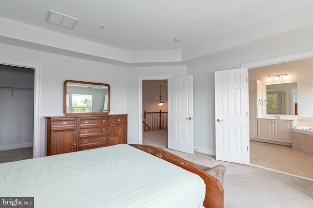 2804 Persimmon Pl Unit D3, Cambridge, MD 21613 - bedroom with visible vents, a closet, a walk in closet, ensuite bath, and light colored carpet