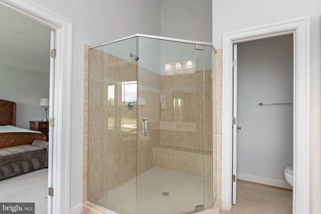 2804 Persimmon Pl Unit D3, Cambridge, MD 21613 - ensuite bathroom with baseboards, a stall shower, tile patterned floors, toilet, and connected bathroom