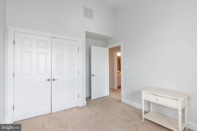 2804 Persimmon Pl Unit D3, Cambridge, MD 21613 - unfurnished bedroom with a towering ceiling, a closet, baseboards, carpet floors, and visible vents
