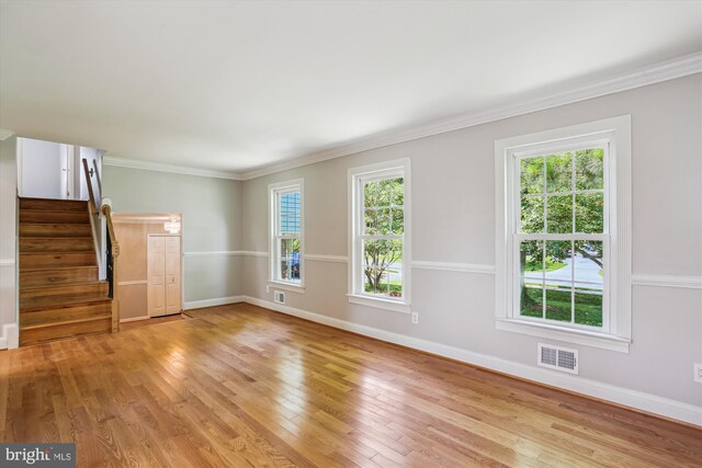 19916 Westerly Ave, Poolesville, MD 20837 - unfurnished living room featuring light wood-style flooring, healthy amount of natural light, and crown molding