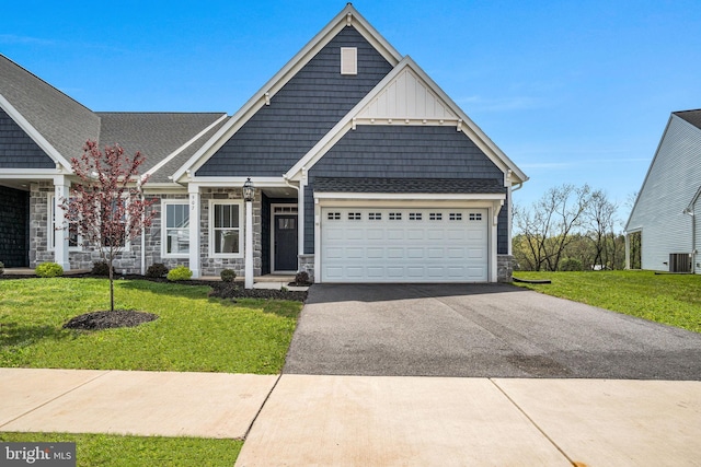 907 Shadowbrooke Dr, Dover, PA 17315 - view of front of home with stone siding, a garage, driveway, and a front yard