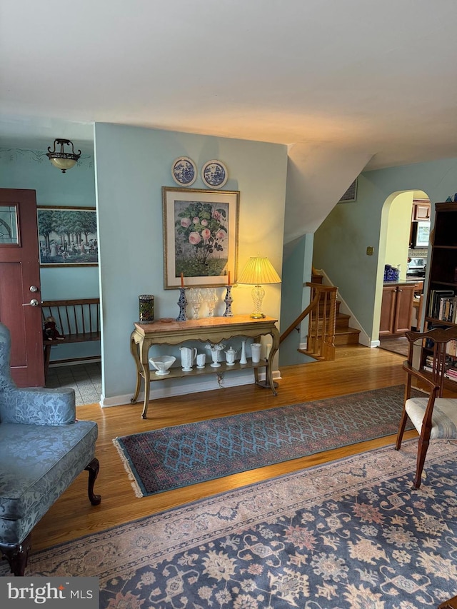 2703 Branch Pike, Cinnaminson, NJ 08077 - living area with arched walkways, baseboards, stairs, and wood finished floors