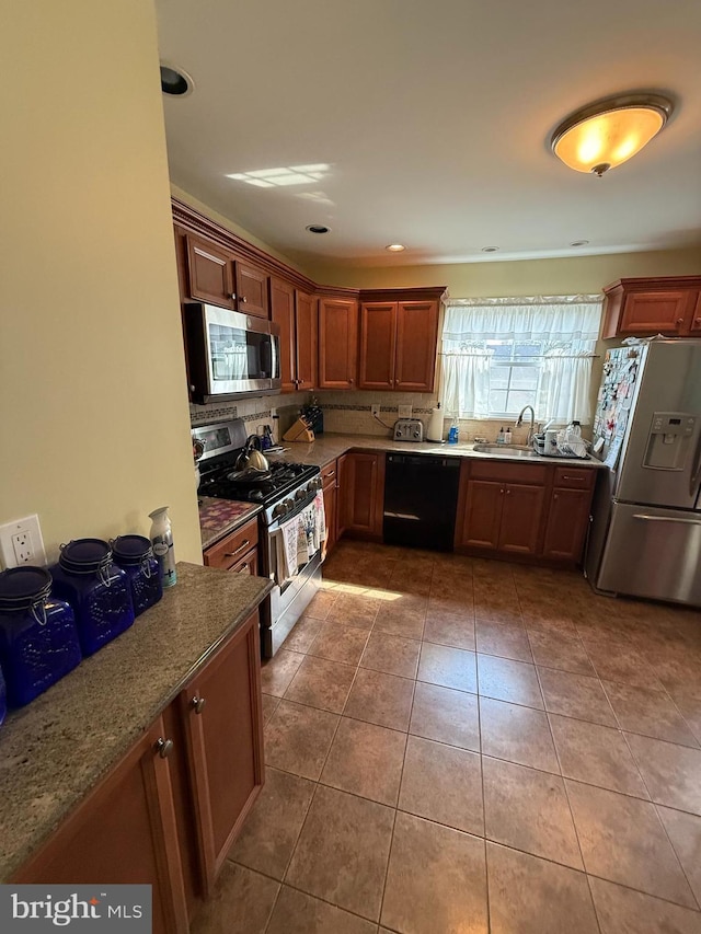 2703 Branch Pike, Cinnaminson, NJ 08077 - kitchen with dark stone counters, a sink, stainless steel appliances, tile patterned floors, and decorative backsplash