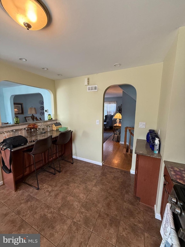 2703 Branch Pike, Cinnaminson, NJ 08077 - dining space with arched walkways, dark tile patterned floors, visible vents, and baseboards