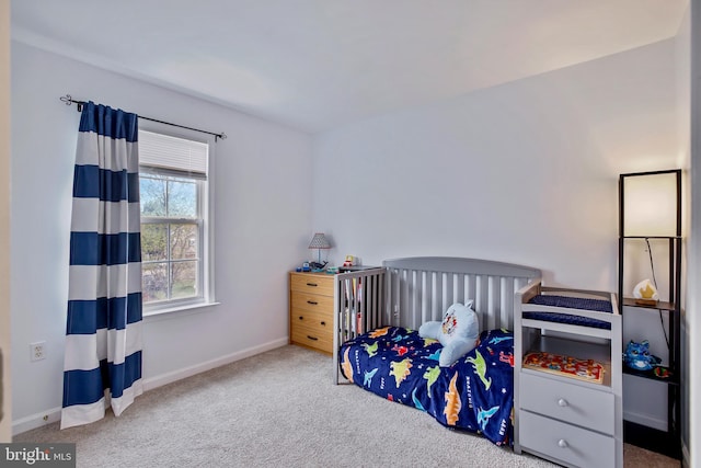 carpeted bedroom featuring baseboards