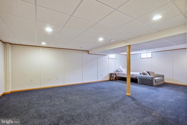 basement with a paneled ceiling, a decorative wall, carpet, and recessed lighting