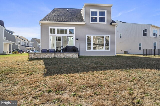 33273 Claremont Ct, Millsboro, DE 19966 - back of house featuring central air condition unit, a lawn, and a patio