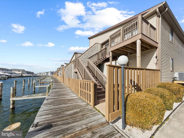 105 120th St Unit 168, Ocean City, MD 21842 - view of property exterior with cooling unit, a boat dock, a water view, and stairs