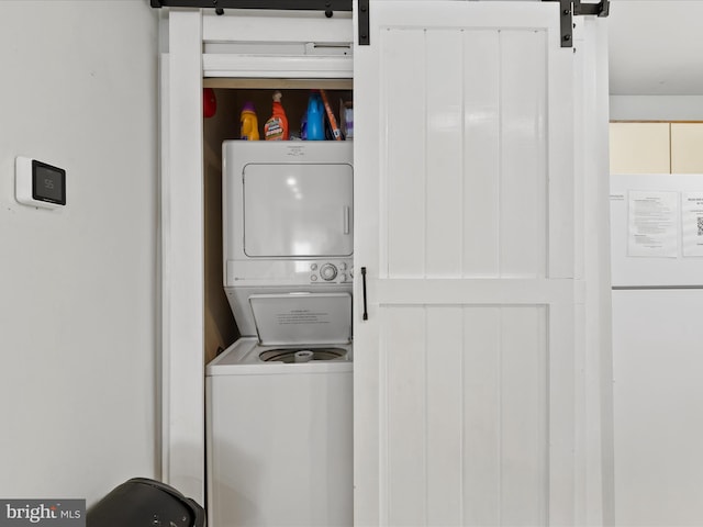 105 120th St Unit 168, Ocean City, MD 21842 - clothes washing area with a barn door, stacked washing maching and dryer, and laundry area