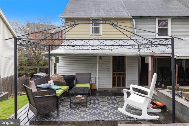 exterior space featuring an outdoor living space, a deck, and roof with shingles