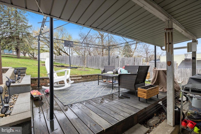 wooden terrace featuring a yard and a fenced backyard