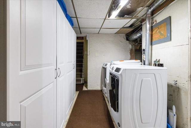 clothes washing area with dark carpet and washer and dryer