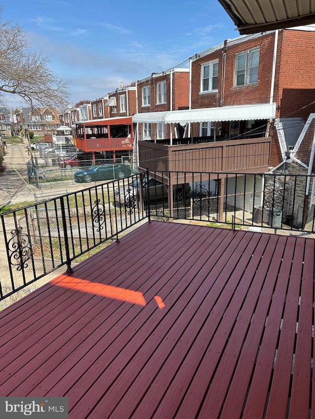 wooden terrace featuring a residential view