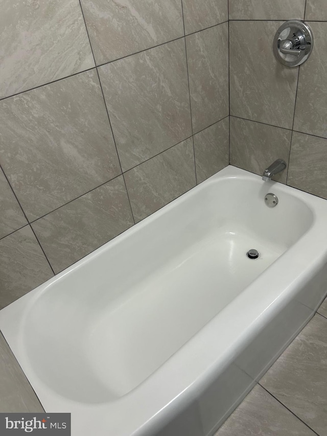 full bathroom featuring a tub to relax in and a shower