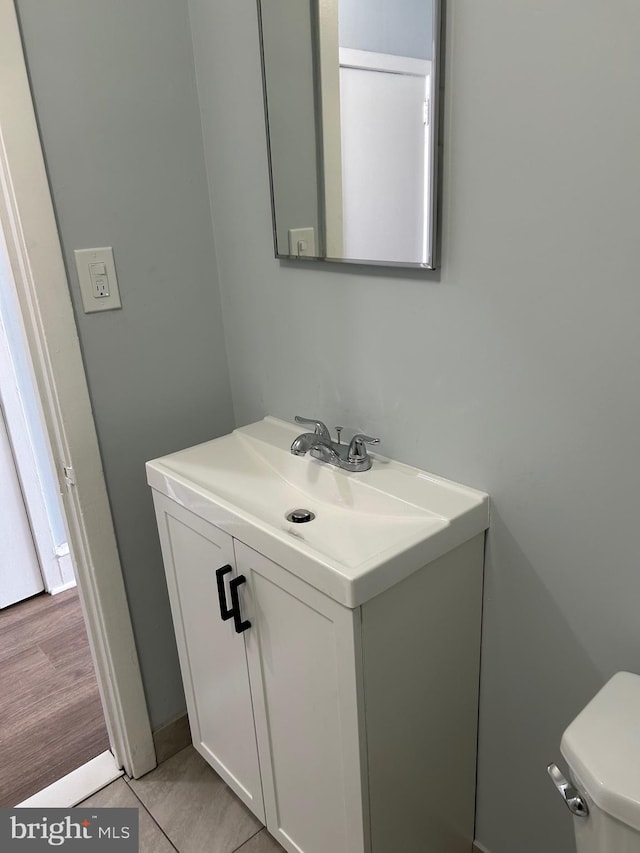 half bath featuring toilet and vanity