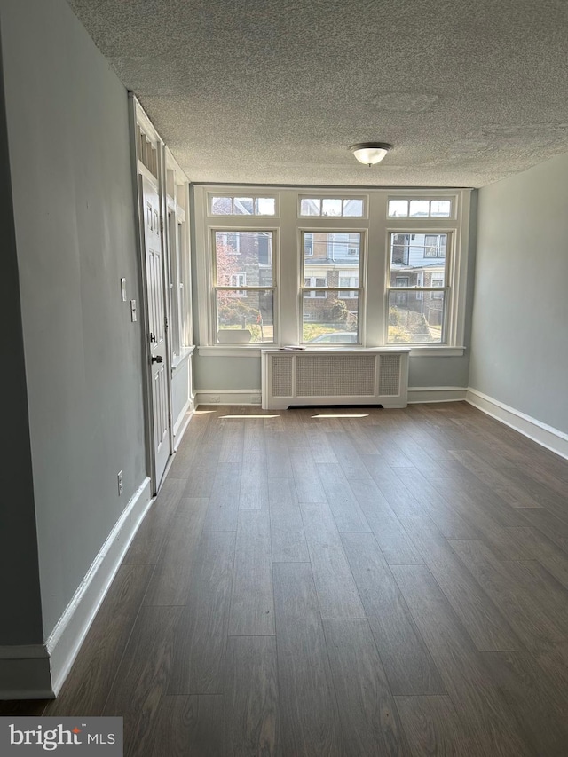 unfurnished sunroom featuring radiator