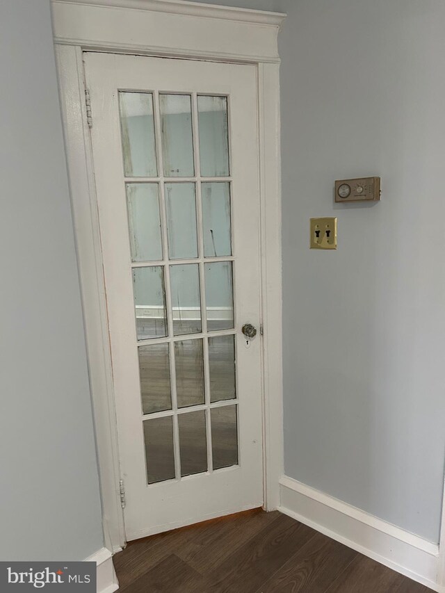 interior details featuring baseboards and wood finished floors