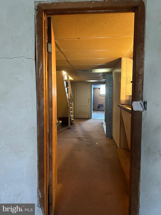 hall with concrete flooring and stairs