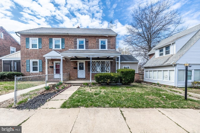 townhome / multi-family property featuring brick siding, fence, a front lawn, and a porch