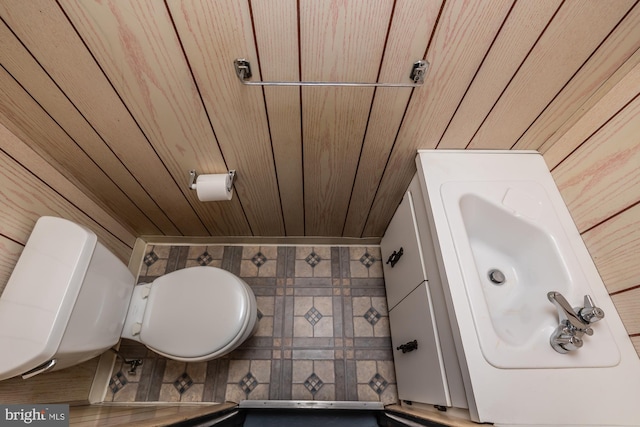 half bath with toilet and wood ceiling