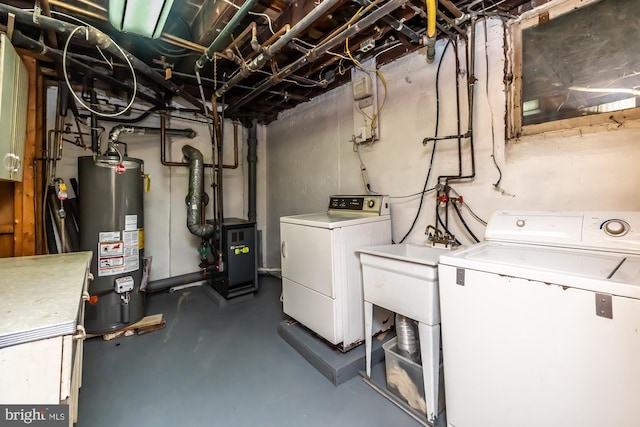 unfinished basement featuring water heater, washing machine and clothes dryer, and a heating unit